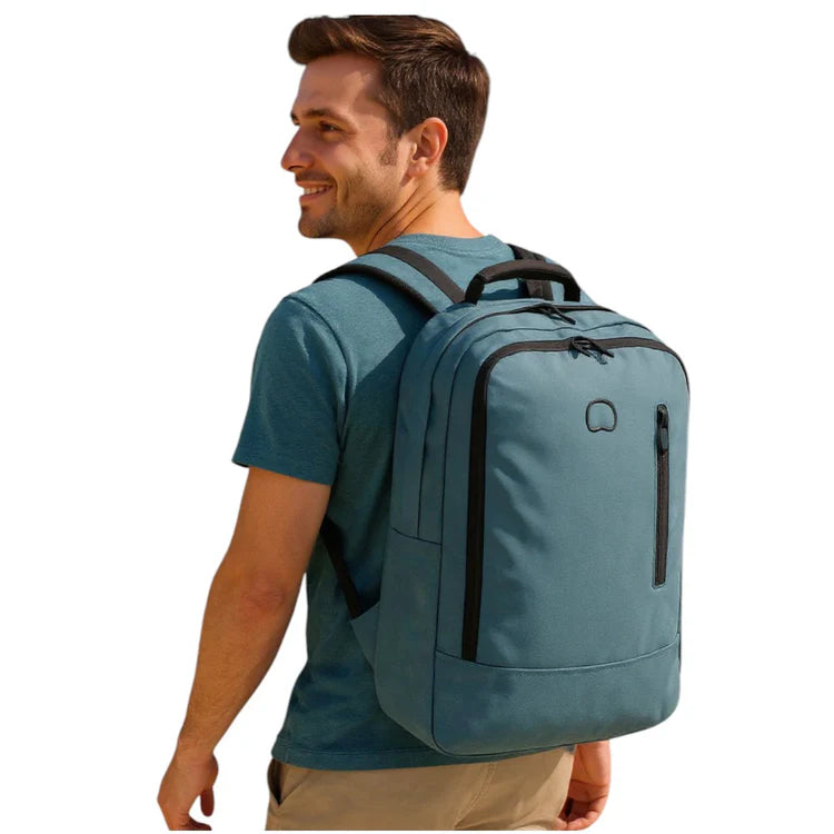 Man wearing Delsey light blue backpack outdoors