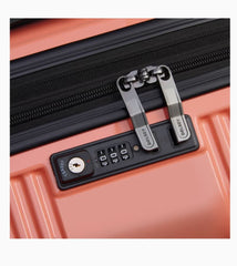 Built-in TSA combination lock on coral Delsey luggage