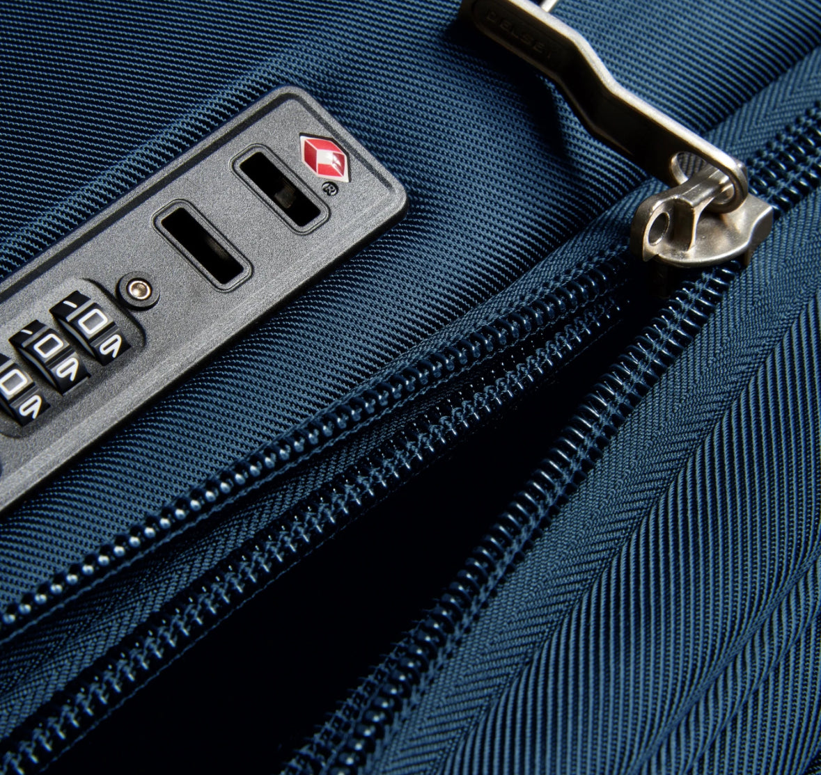 Open TSA combination lock on a blue Delsey suitcase